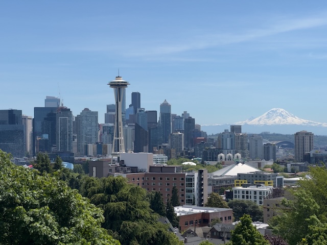 Seattle skyline with Space Needle and Mount Rainier visible in the background on a clear day